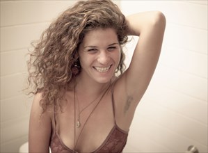 Smiling Caucasian woman showing armpit hair