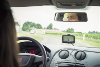 Caucasian woman driving car with GPS navigation