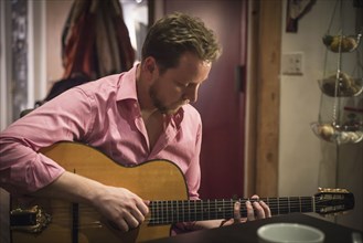 Caucasian man playing guitar