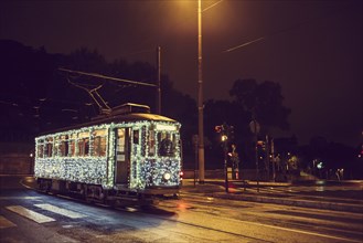 Illuminated streetcar on city street