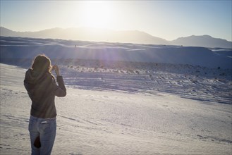 Caucasian woman photographing White Sands National Park
