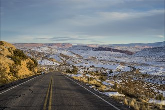 Empty road through snowy remote landscape