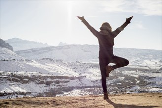 Caucasian woman practicing yoga on remote hilltop
