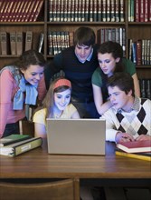 Students using laptop in library