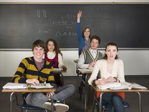 Student raising her hand in classroom