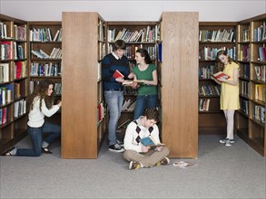 Students reading books in library