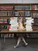 Student sitting with books in library