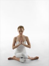 Caucasian woman meditating in yoga pose