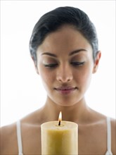 Close up of woman admiring candle