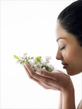 Close up of woman smelling flowers