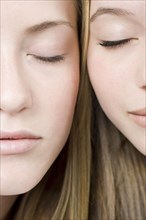 Close up of faces of women with eyes closed