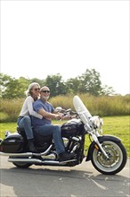 Older couple riding motorcycle