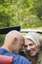 Older couple sitting in convertible