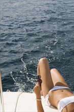 Woman wearing bikini on boat deck