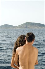 Rear view of couple admiring ocean view