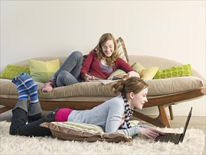 Caucasian women reading in living room