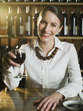 Caucasian woman drinking wine in restaurant