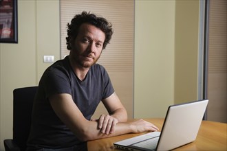 Caucasian man using laptop on desk