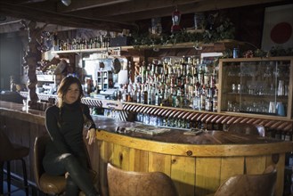 Caucasian woman sitting in empty bar