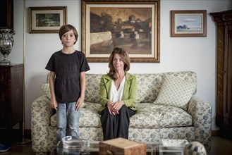 Caucasian grandmother and grandson in living room