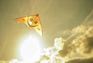 Kite flying in sunny sky