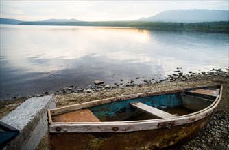Dilapidated boat at rural lake