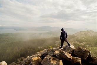 Caucasian hiker standing on rocky hilltop