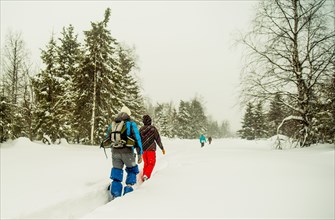 Caucasian hikers walking in deep snow