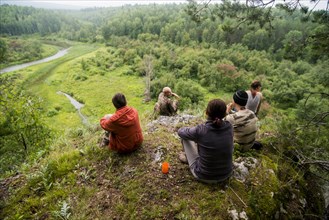 Caucasian friends admiring scenic view from rural hilltop