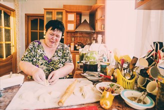 Caucasian woman cooking in kitchen