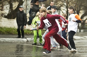 Caucasian children racing on street