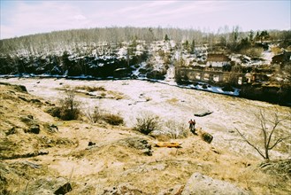 Caucasian men standing near remote river
