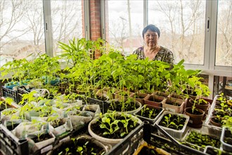 Caucasian woman standing with indoor plants