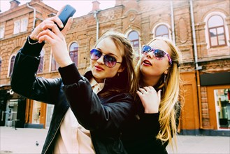 Women taking selfie in city