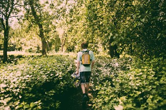 Caucasian man hiking in lush park