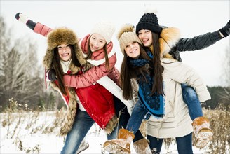 Caucasian girls playing in snow