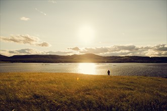 Caucasian man standing at lake