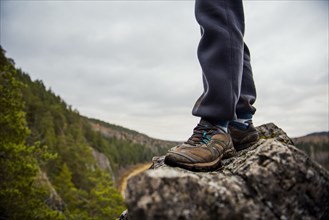 Man standing on rock in remote valley