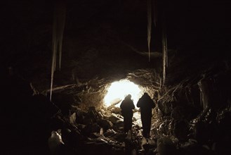 Caucasian hikers exploring cave