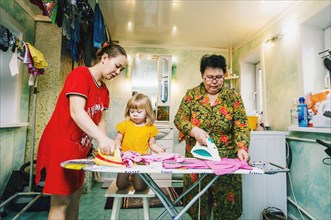 Caucasian women ironing laundry