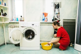 Caucasian woman hand-washing laundry