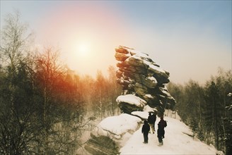 Caucasian hikers on snowy remote hilltop