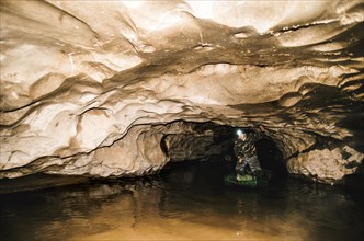 Caucasian hiker standing in cave