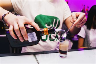 Bartender pouring shot in nightclub