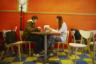 Caucasian couple eating in restaurant