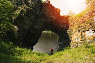 Caucasian man under rock formation arch