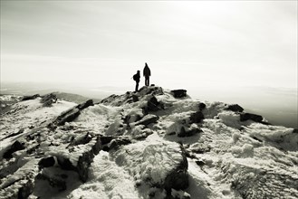Couple hiking on mountain in winter