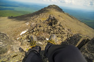 Legs at the edge of mountain