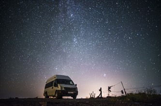 Camper van under starry sky