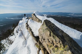 Caucasian man hiking on mountain in winter